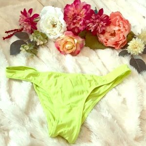 Neon yellow cheeky bikini bottoms.